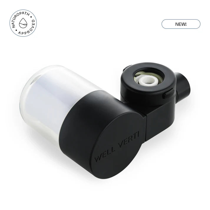 Black and clear device with 'WELL VERTI' branding on a white background. 'Naturopath Approved' and 'NEW!' labels. Ensure your water stays pure with the HaloDrop™ Tap Filter Refill. Quick-change cartridge designed to maintain elite filtration for skin and hair wellness. Monecious is a Well Verti Australian stockist. Shop now!