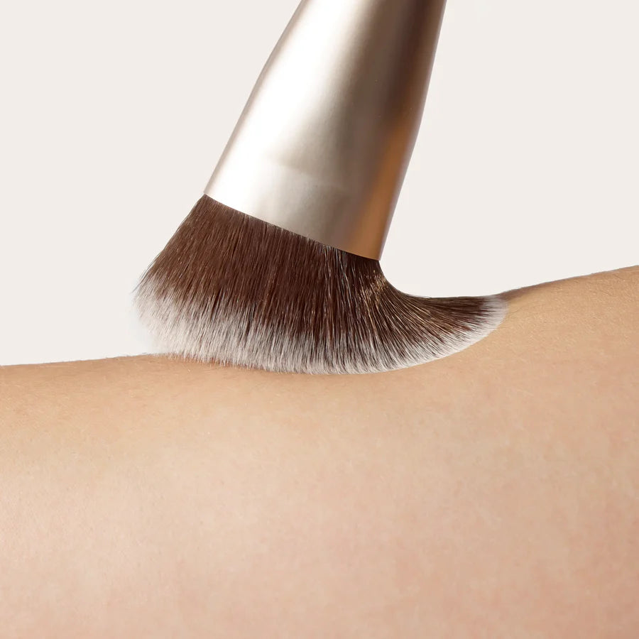 A versatile makeup blending brush designed for effortless application. Featuring a unique sloped shape and ultra-soft vegan fibres, this multiuse brush buffs, blends and diffuses makeup seamlessly for a smooth, airbrushed finish. Australian Jane Iredale stockist.