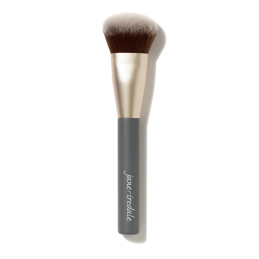 A versatile makeup blending brush designed for effortless application. Featuring a unique sloped shape and ultra-soft vegan fibres, this multiuse brush buffs, blends and diffuses makeup seamlessly for a smooth, airbrushed finish. Jane Iredale stockist.