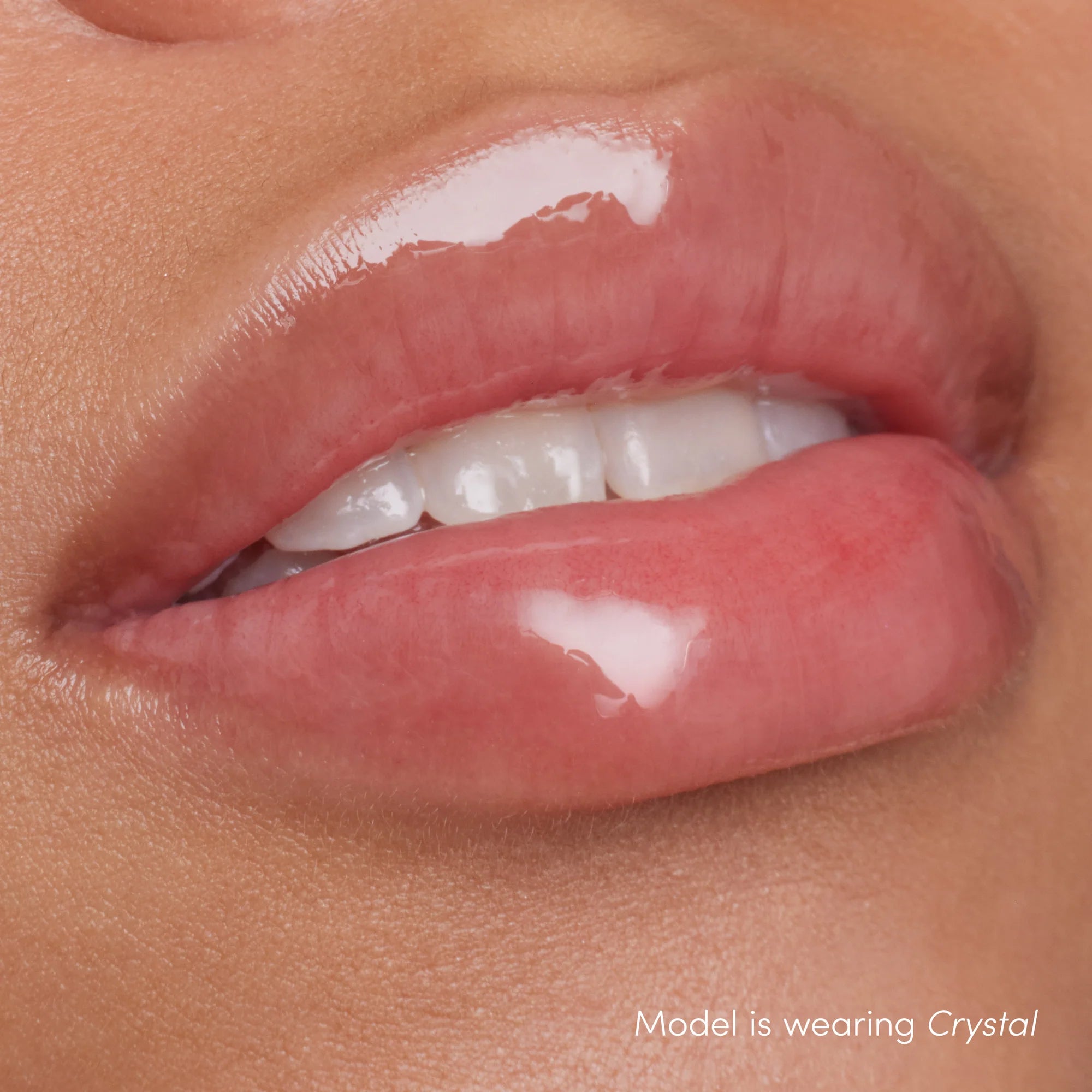 Colorluxe High Impact Lip Glaze - Shade Crystal on the lips. Full-bodied, never-sticky lip glaze delivers lustrous color, supreme shine and a cushiony, comfortable feel. Visually volumizes and smooths for a fuller-looking lip. Monecious is a Jane Iredale Australian stockist. Shipping all over Australia.